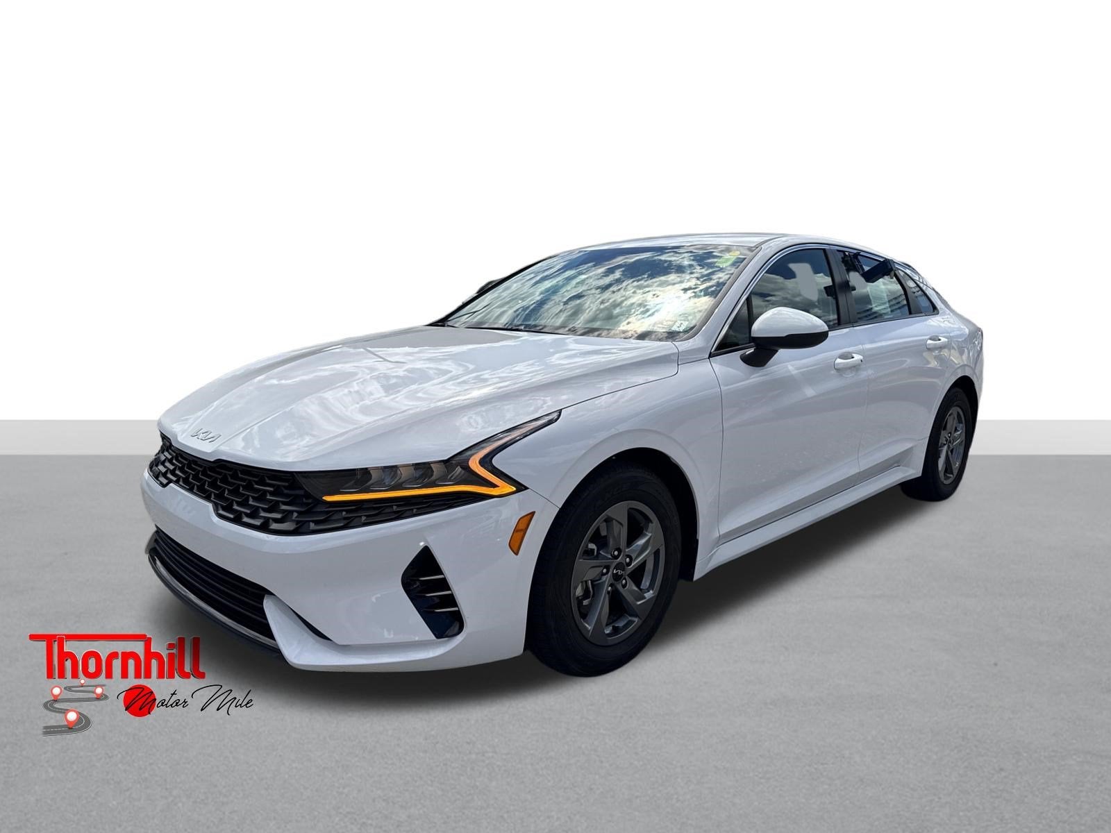 2024 Kia K5 LXS in Glacial White Pearl — front three-quarter view